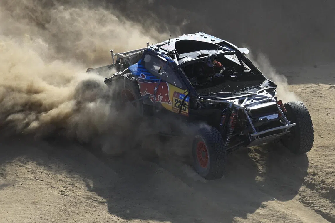 Spanish driver Carlos Sainz steers his car assisted by co-driver Lucas Cruz during Stage 2B of the 47th Dakar Rally.