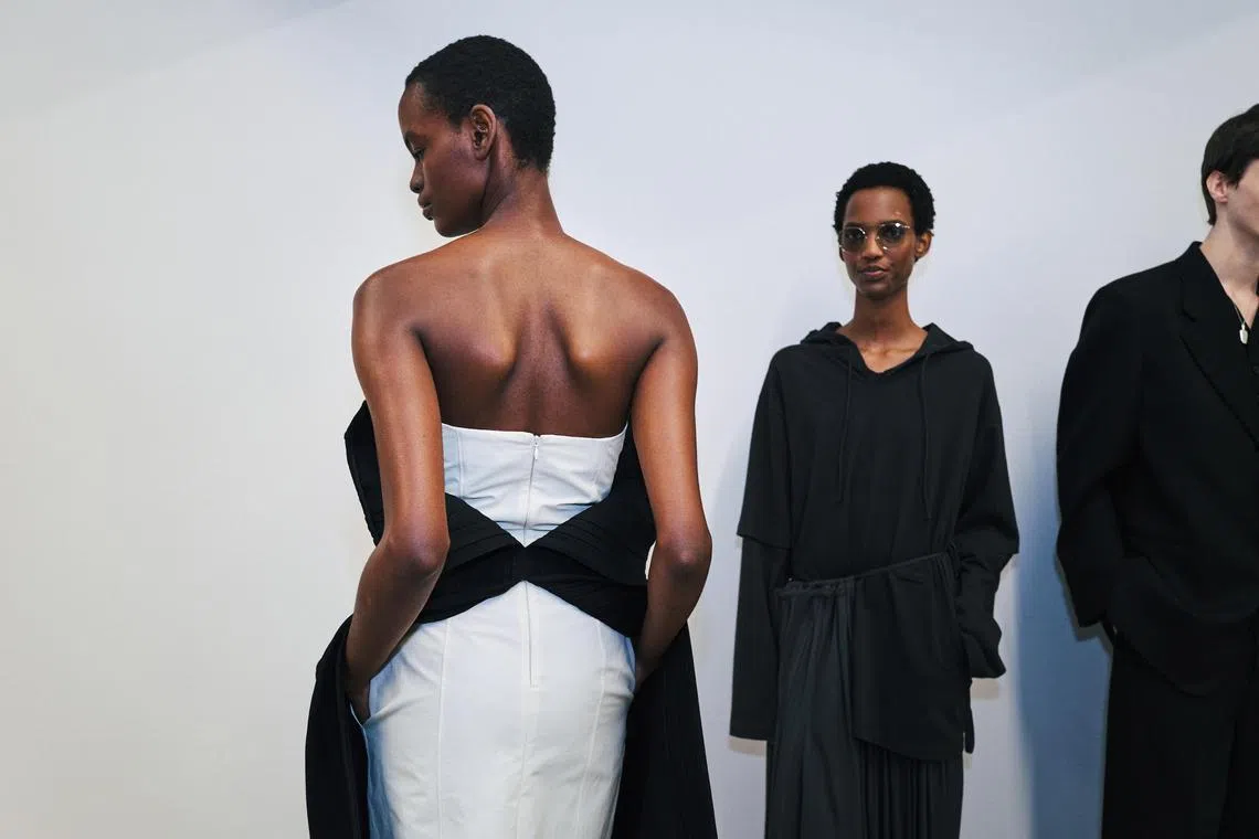 A strapless dress peels off to reveal the slip beneath at the Calvin Klein fashion show in New York in February 2025. (Simbarashe Cha/The New York Times)