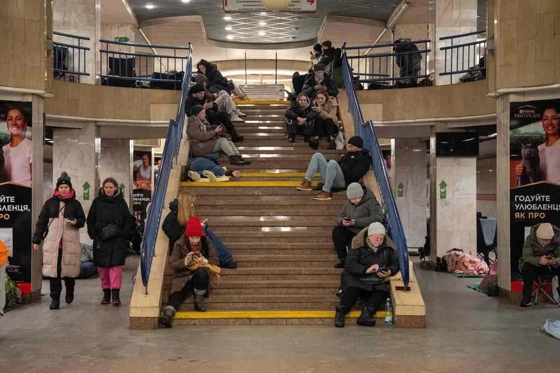 People taking shelter at a metro station in Kyiv on Jan 9, amid Russian drone and missile attacks on the Ukrainian capital.