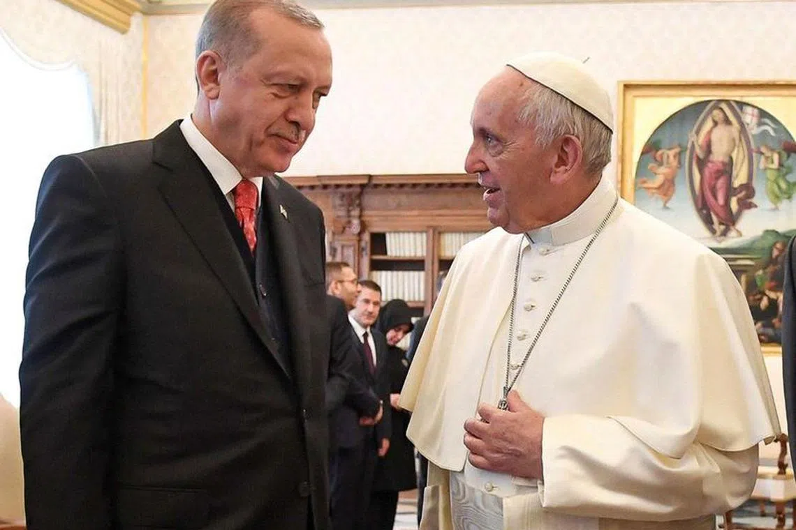 Pope Francis talks with Turkish President Tayyip Erdogan during a private audience at the Vatican, February 5, 2018. REUTERS/Alessandro Di Meo/Pool/File Photo