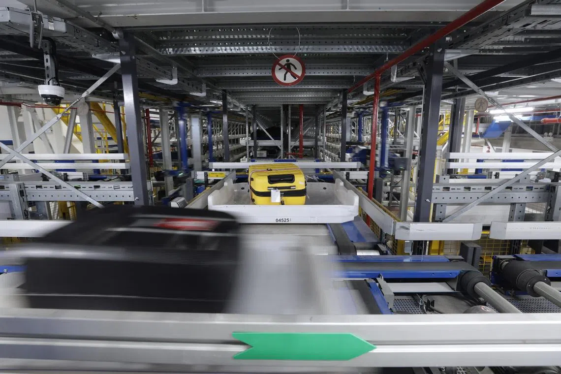 Embargoed till 6pm, 19 December 2023.

Baggage being transported in and out of the storage module in the new fully automated Early Baggage Storage (EBS) facility at Changi Airport Terminal 2 on Dec 18, 2023. The facility has a maximum capacity of up to 2400 bags, and features 16 storage modules (each storing 150 bags). ST PHOTO: KEVIN LIM ilchangi18
