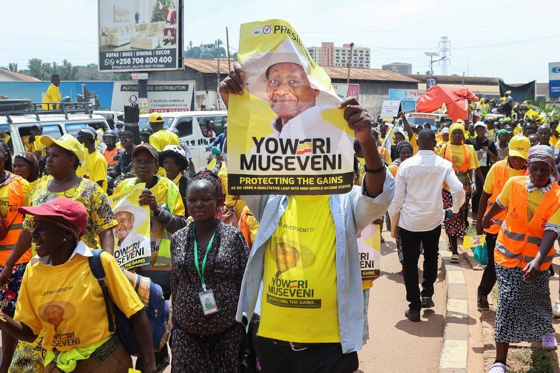 Supporters of Uganda's president Yoweri Museveni march along the street on Jan 13, ahead of an election in which he will stand for a seventh term.
