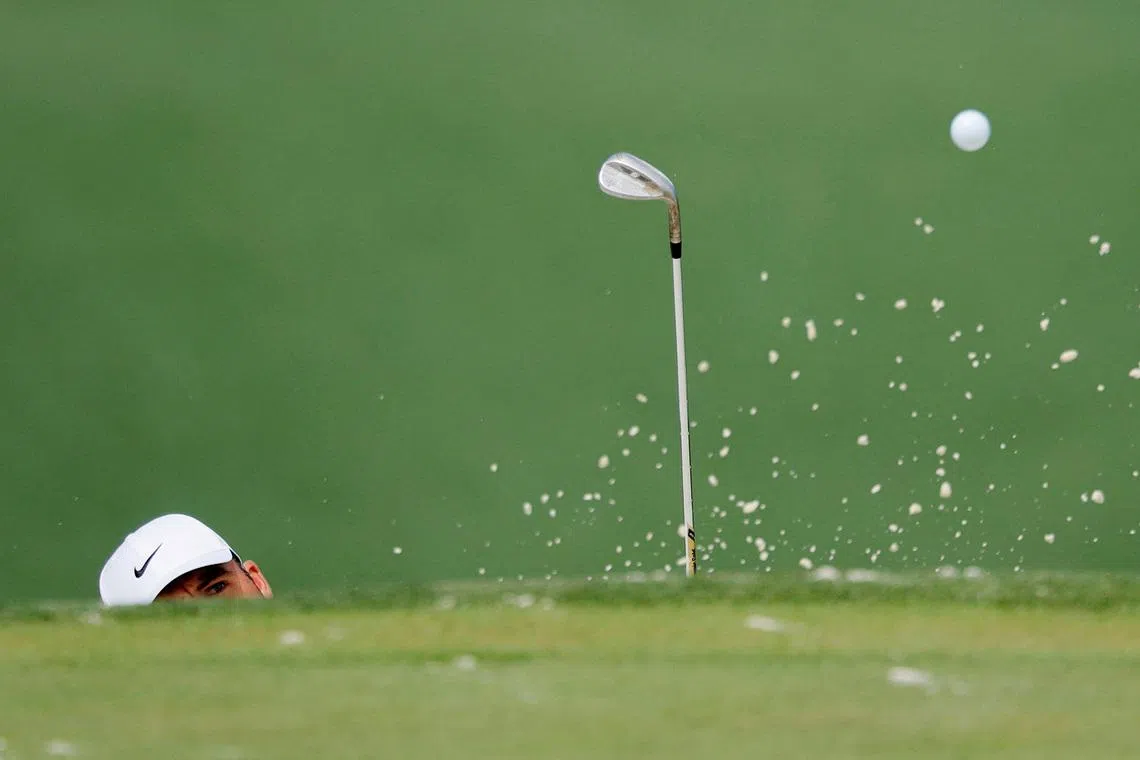 Scottie Scheffler of the US plays out from the bunker during a practice round, during the Masters golf tournament at the Augusta National Golf Club, in Augusta, Georgia, US, on April 7, 2026.