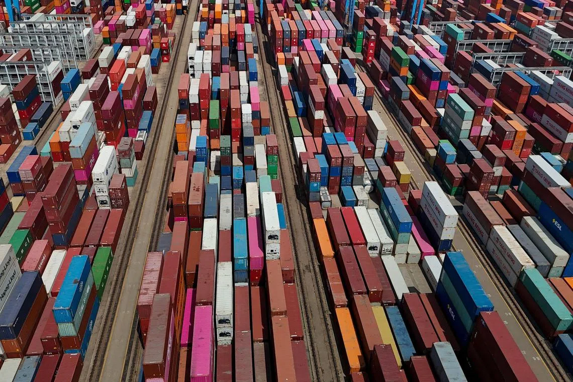 This aerial photograph taken on May 14, 2024 shows shipping containers stacked at a port in Qingdao, in eastern China's Shandong province. (Photo by AFP) / China OUT
