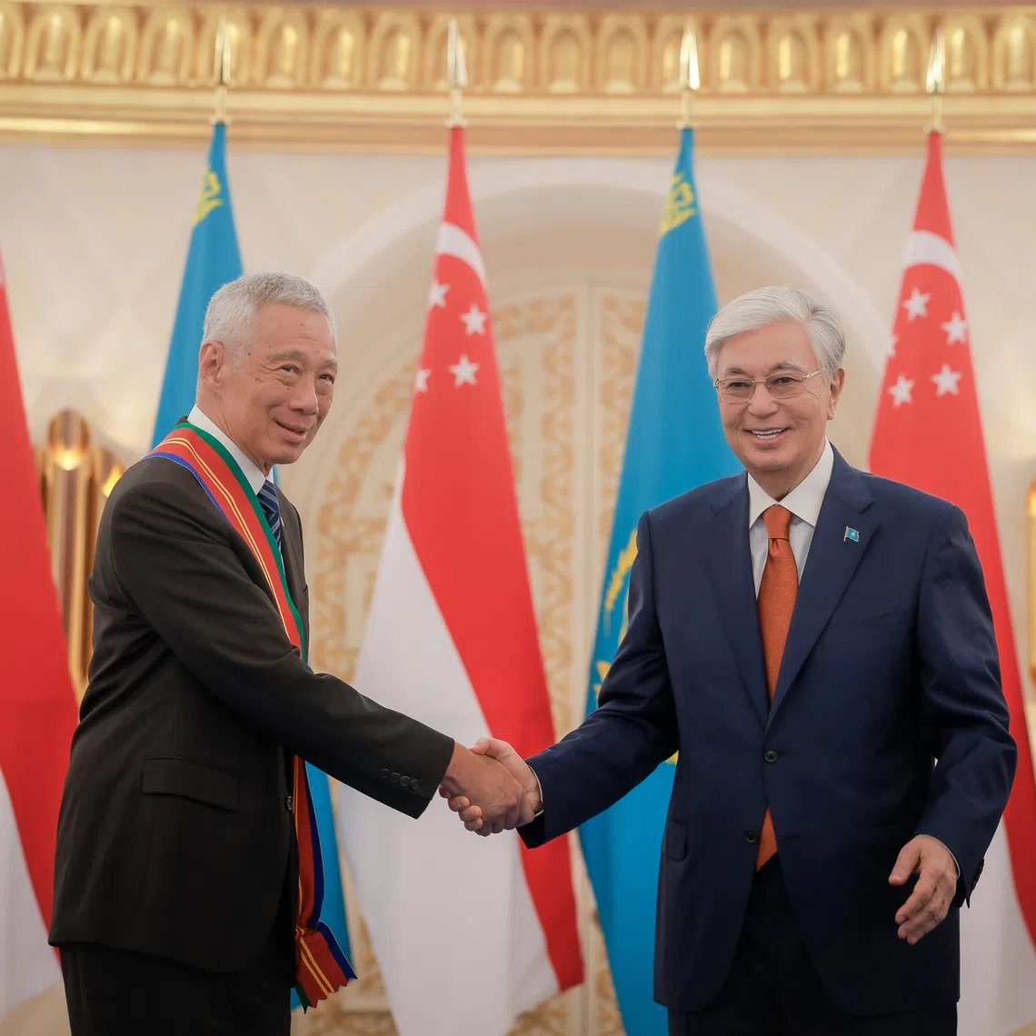 Senior Minister Lee Hsien Loong (left) is conferred the Order of Dostyk, First Class, by Kazakhstan President Kassym-Jomart Tokayev at Akorda Presidential Palace in Astana on Aug 26.