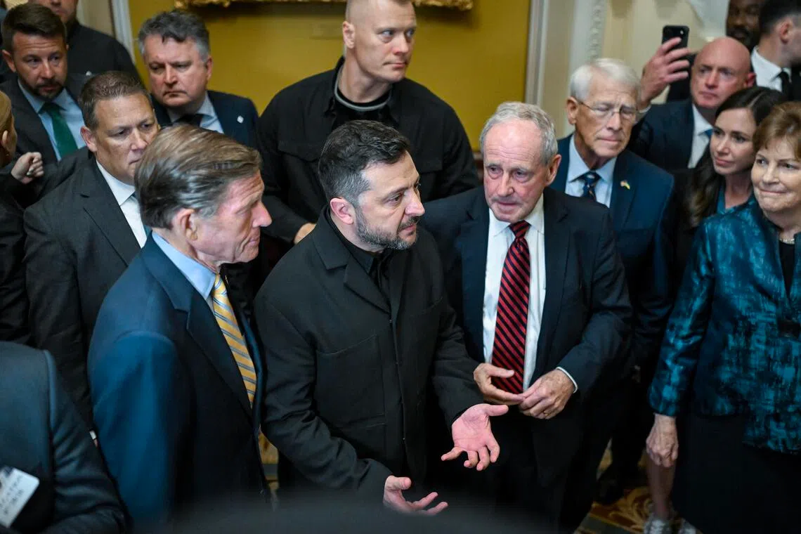 Ukrainian President Volodymyr Zelensky (centre) speaking to reporters after a meeting with US senators in Washington on July 28.