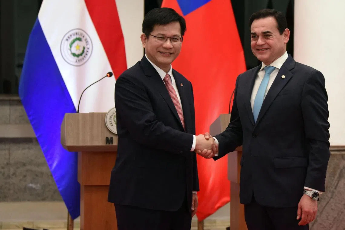 Taiwan's Foreign Minister Lin Chia-lung (L) and Paraguay's Foreing Minister Ruben Ramirez shake hands after delivering a press statement at the Foreign Ministry in Asuncion on July 11, 2025. (Photo by DANIEL DUARTE / AFP)