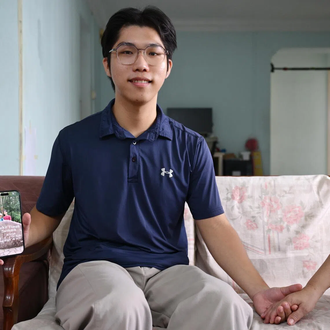 Caregiving is not a burden forced upon him, but a conscious choice, said Samuel Chew, holding his mother with one hand and his late father's photo in another.