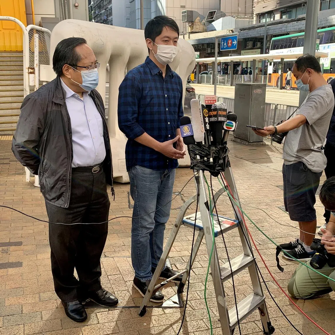 Former lawmaker Ted Hui Chi-fung speaks to members of the media after he was released on bail, next to Albert Ho, outside Western Police Station in Hong Kong, China November 18, 2020. REUTERS/Yoyo Chow/File Photo