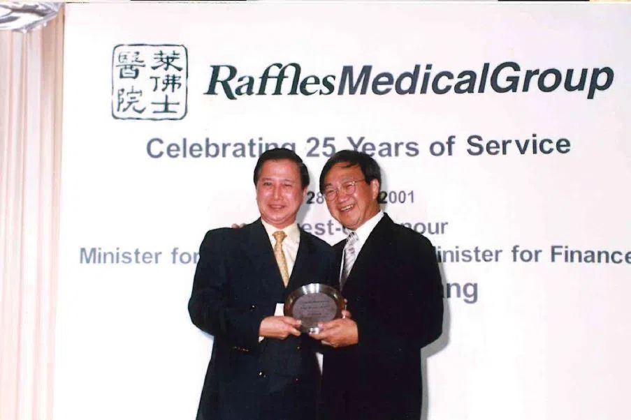 Dr Alfred Loh and Dr Loo Choon Yong celebrating 25 years of Raffles Medical Group in 2001