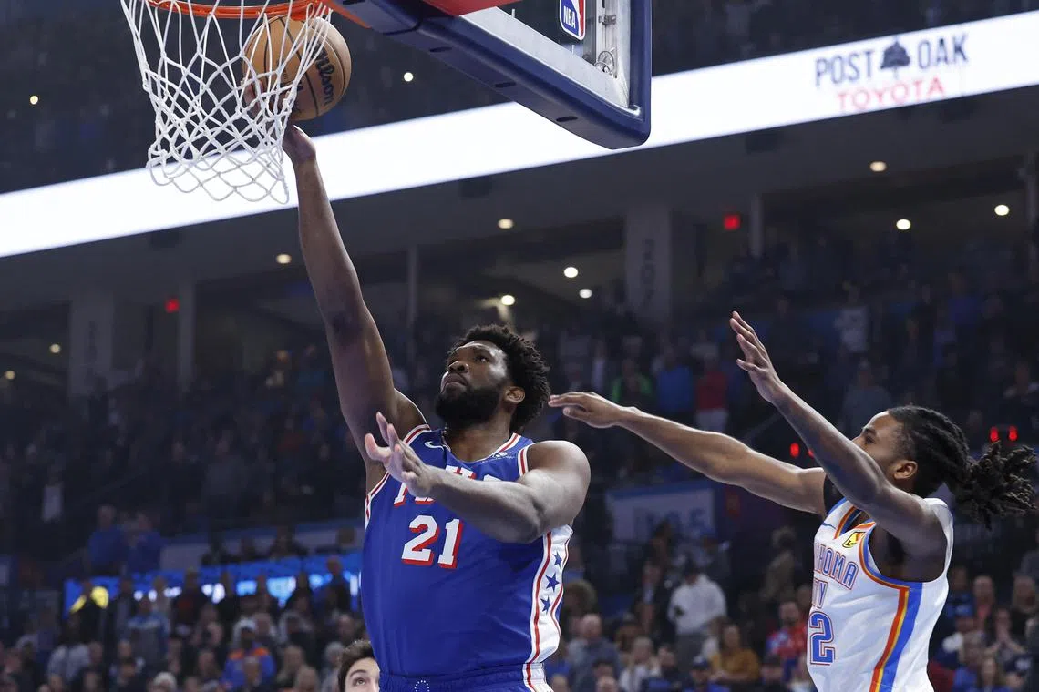 Philadelphia 76ers centre Joel Embiid going to the basket as Oklahoma City Thunder guard Cason Wallace defends during the Sixers 127-123 road win on Nov 25. Embiid scored 35 points and drained six free throws in the final 9.8 seconds.