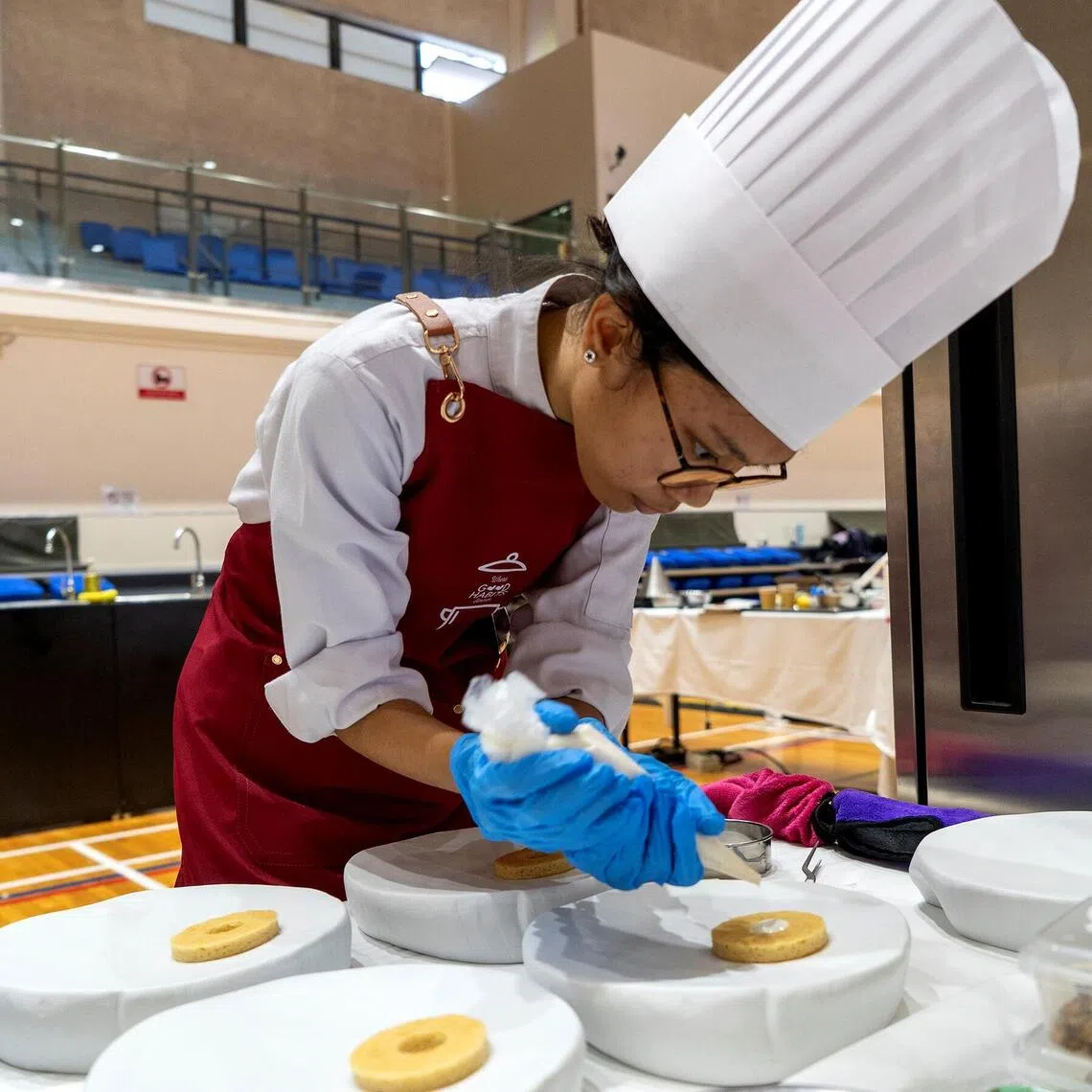 Higher Nitec hospitality student Nur Iman Sulaiman at a cooking competition in May, in which participants were tasked with coming up with meals that incorporated heart-healthy canned ingredients.