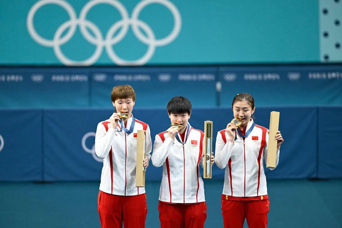 (From left) China's Wang Manyu, Sun Yingsha and Chen Meng with their gold medals.