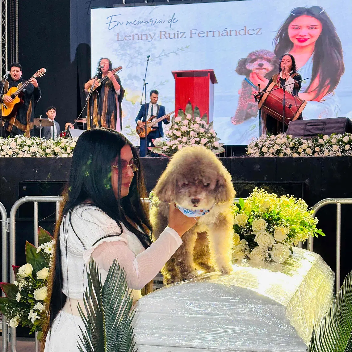 Jessica Florez, the sister-in-law of Colombian lawyer Lenny Ruiz, who died protecting her dog Salomon during the Aug 10 earthquake, with Salomon during Ruiz’s funeral on Aug 13.