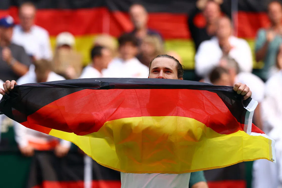 Tennis - Davis Cup - Qualifiers - Second Round - Germany v Croatia - Heristo Arena, Halle, Germany - September 20, 2026 Germany's Alexander Zverev celebrates with his national flag after winning his match against Croatia's Dino Prizmic and qualifying for the Davis Cup REUTERS/Piroschka Van De Wouw