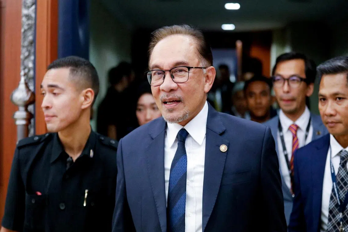 FILE PHOTO: Malaysia's Prime Minister Anwar Ibrahim leaves the lower house of parliament after receiving a vote of confidence, in Kuala Lumpur, Malaysia December 19, 2022. REUTERS/Hasnoor Hussain/File Photo