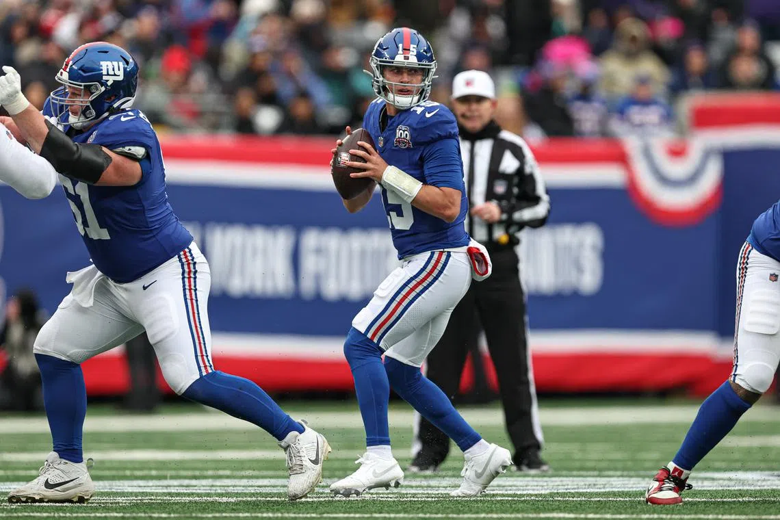 Dec 15, 2024; East Rutherford, New Jersey, USA; New York Giants quarterback Tommy DeVito (15) drops back to pass during the first half against the Baltimore Ravens at MetLife Stadium. Vincent Carchietta-Imagn Images/File Photo