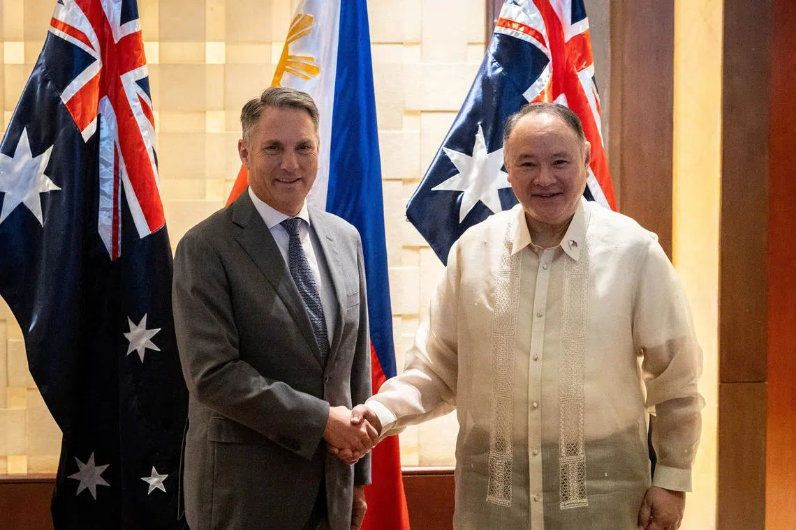 Philippine Defence Minister Gilberto Teodoro and his Australian counterpart Richard Marles shake hands ahead of their bilateral meeting in Makati City, Metro Manila, Philippines, August 22, 2025. REUTERS/Eloisa Lopez