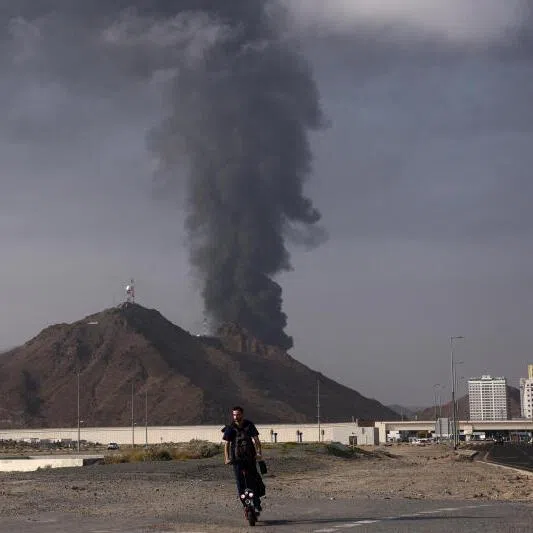 Smoke rising in the Fujairah oil industry zone after debris from an intercepted drone set off a fire.