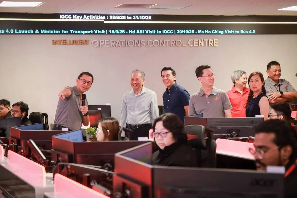 Transport Minister Jeffrey Siow (third from left), accompanied by SMRT chairman Seah Moon Ming (second from left) and SMRT Buses managing director Tan Peng Kuan (fourth from left), touring the Mobility Command and Control Centre in Gali Batu Bus Depot on Aug 28.
