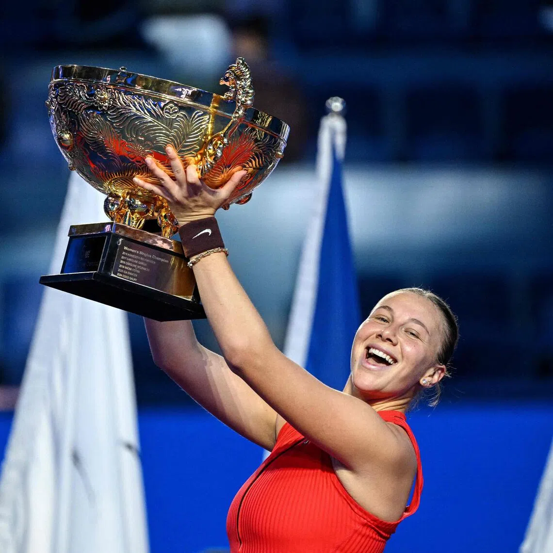 Amanda Anisimova celebrates with the trophy after winning the China Open in Beijing on Oct 5, 2025. 