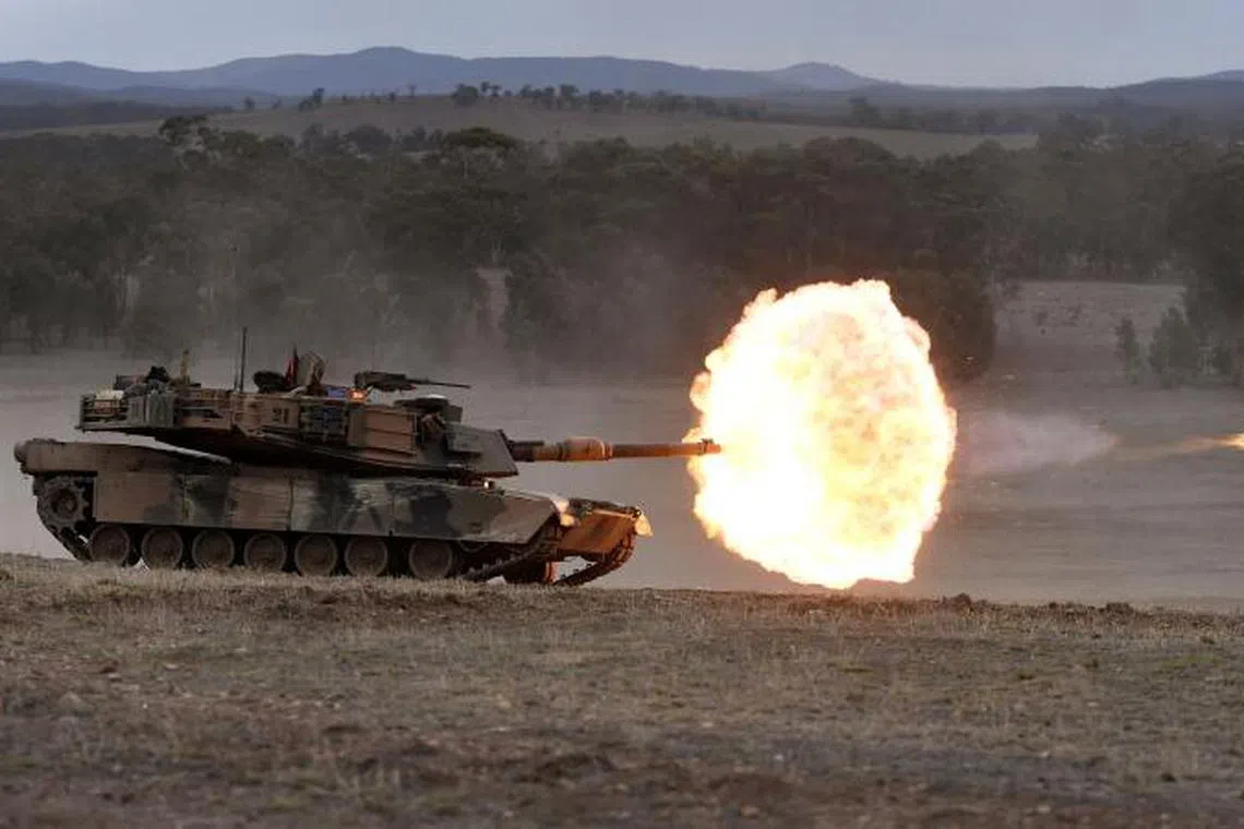A file photo taken on May 9, 2019 shows an Australian Army M1A1 Abrams main battle tank firing a round at a target during Exercise Chong Ju, a live fire demonstration showcasing the army's joint combined arms capabilities, at the Puckapunyal Military Base some 100 kilometres north of Melbourne.