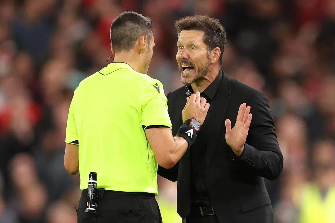 Referee Maurizio Mariani talking to Atletico Madrid coach Diego Simeone.  The Argentinian was sent off for a furious reaction towards Liverpool fans following the Reds' late winner in the 3-2 Champions League triumph at Anfield on Sept 17.