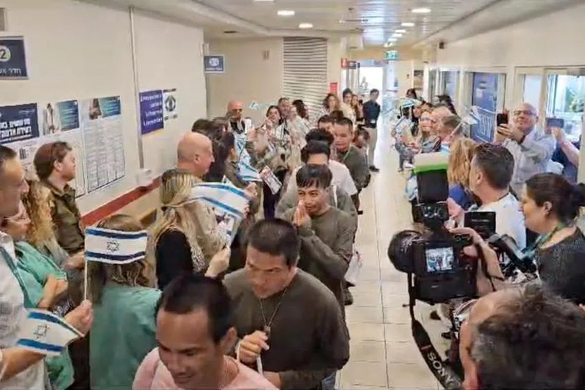 FILE PHOTO: Thai citizens who were released from the Gaza Strip after being taken hostage by the Palestinian Islamist militant group Hamas during the deadly October 7 attack on Israel, attend a leaving ceremony after being discharged from Shamir Medical Center (Assaf Harofeh), in Be'er Ya'akov, Israel November 29, 2023, in this still image obtained from a video. Shamir/Handout via REUTERS/File photo