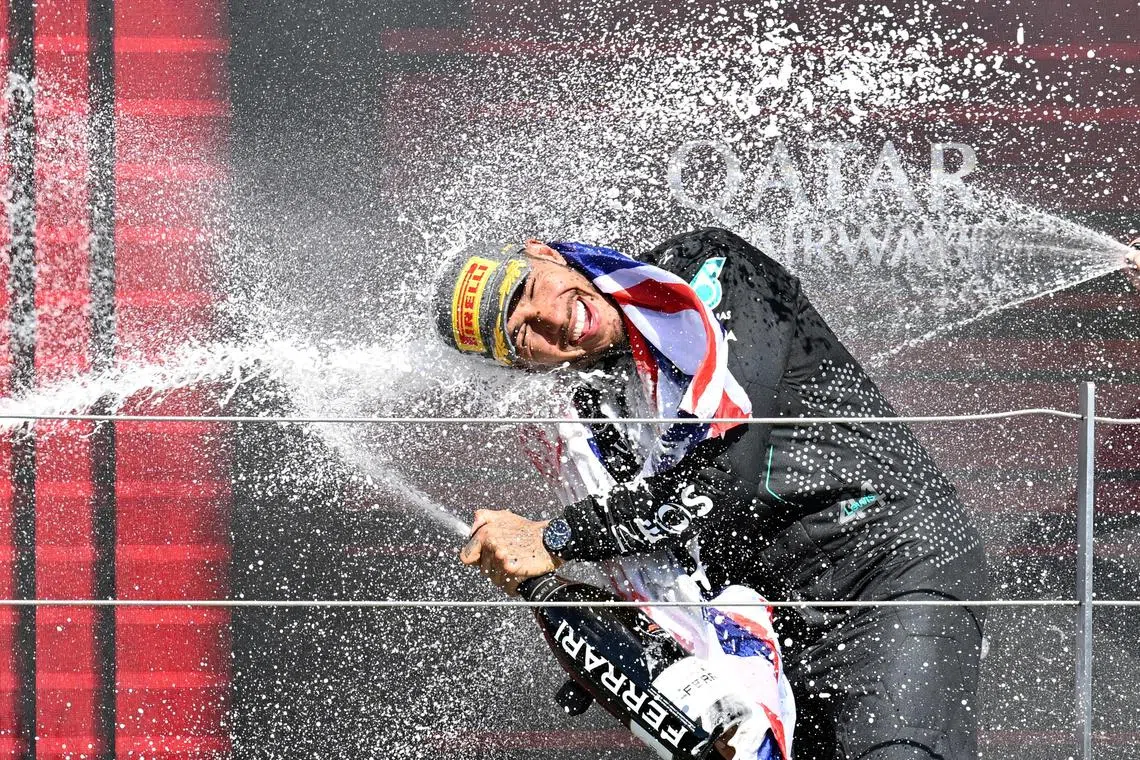 Lewis Hamilton celebrates on the podium after winning the British Grand Prix in front of his home fans.