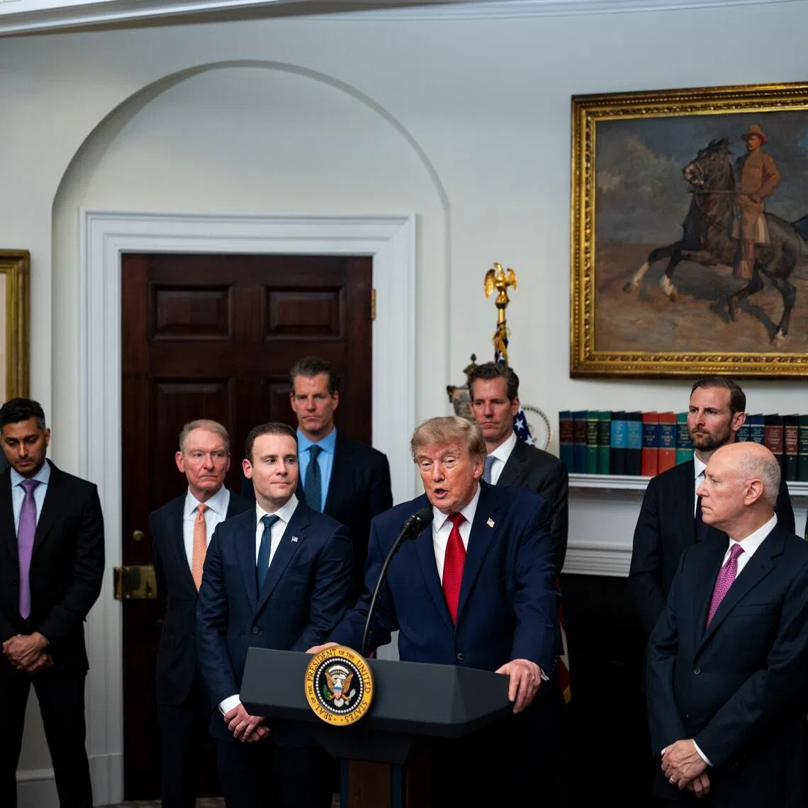 US President Donald Trump (centre) speaks during a meeting with crypto and prediction market executives in the White House in Washington on Aug 19.