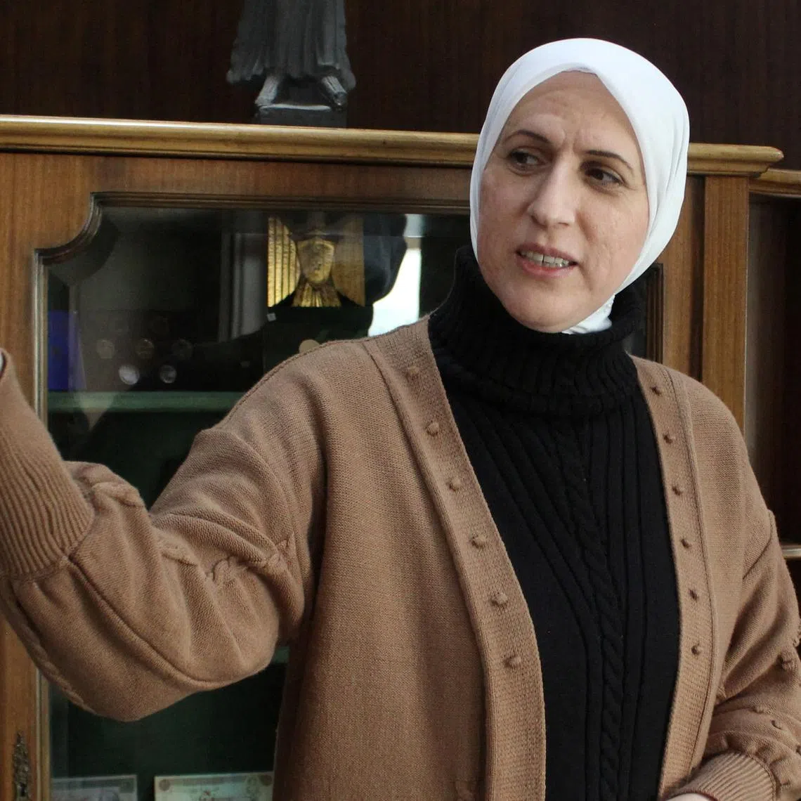 Syria's new central bank governor Maysaa Sabreen gestures at her office in the central bank in Damascus,Syria, January 12, 2025. REUTERS/Firas Makdesi