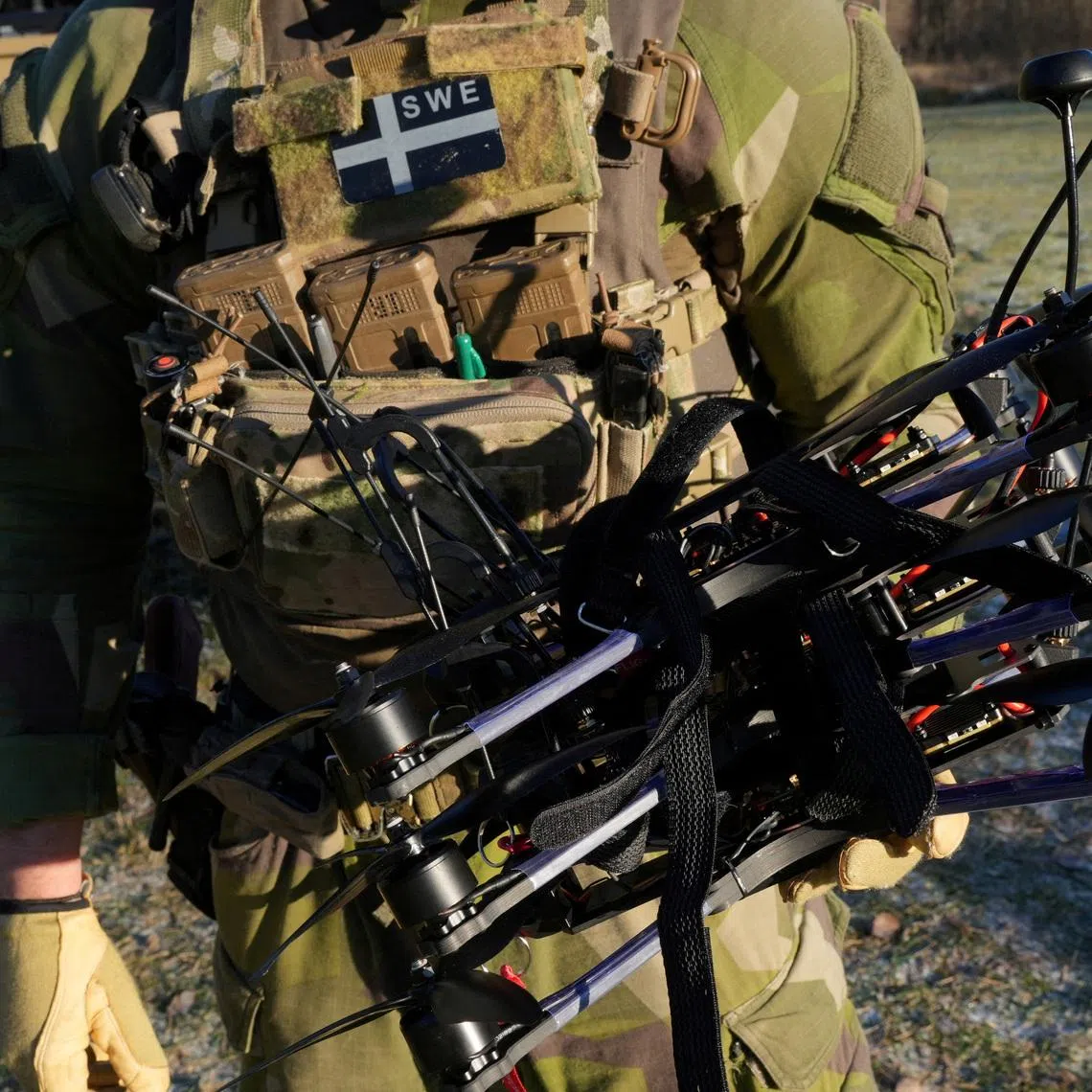 FILE PHOTO: A soldier from Sweden's 31st Ranger Battalion holds drones after using them during a training demonstration in Karlsborg, Sweden, November 21, 2025. REUTERS/Tom Little/File Photo