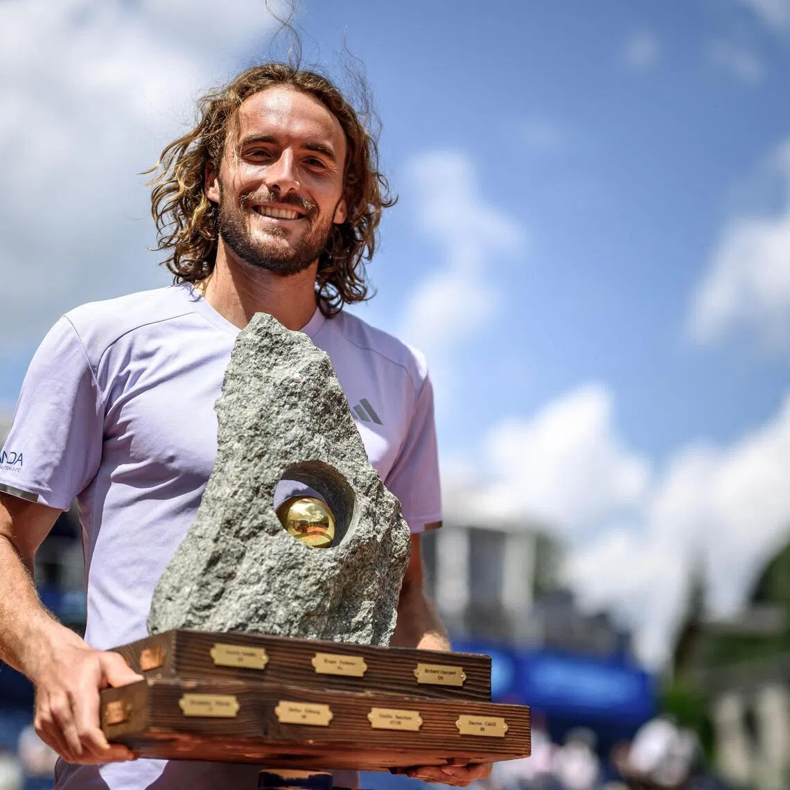 Greece's Stefanos Tsitsipas poses with the trophy following his victory against Belgium's Raphael Collignon during their men's singles final match at the Swiss Open tennis tournament in Gstaad, on July 19, 2026. (Photo by Fabrice COFFRINI / AFP)
