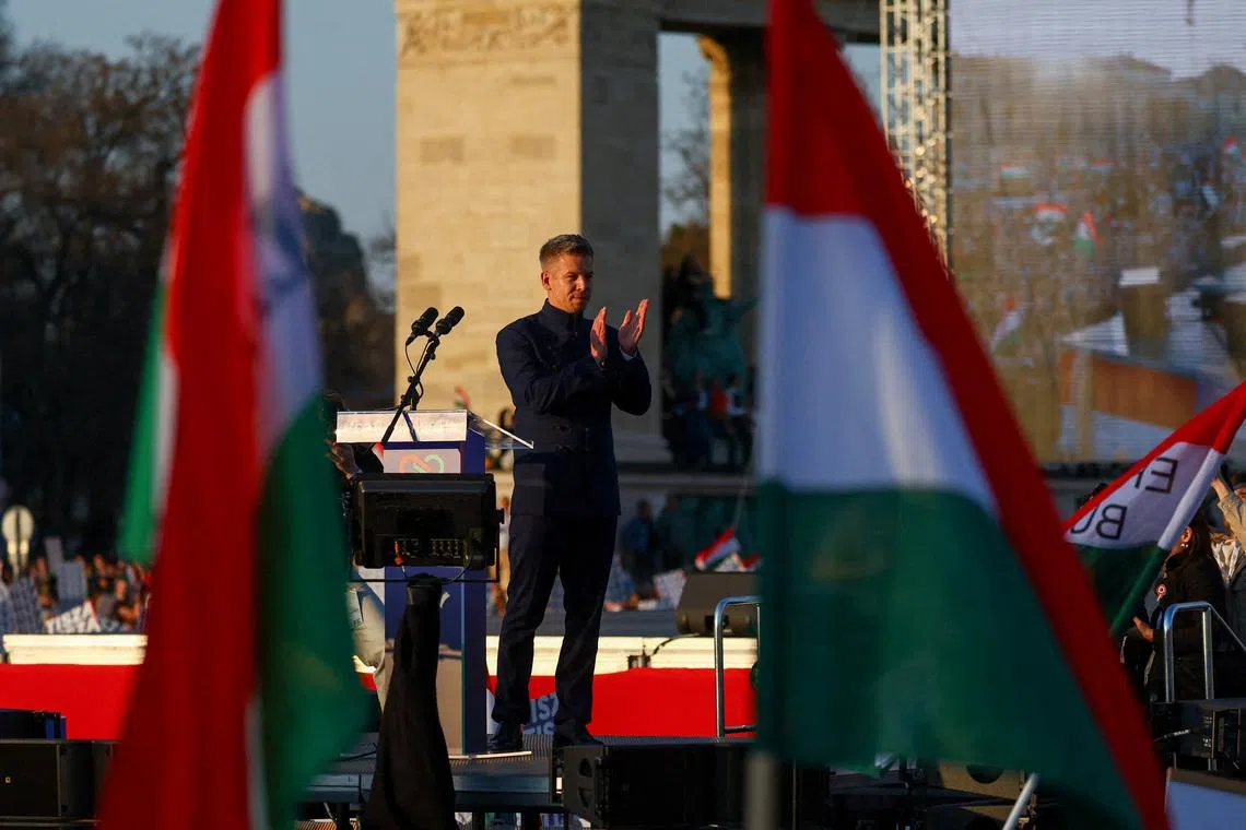 FILE PHOTO: Peter Magyar, leader of the opposition Tisza party, claps on stage during Hungary's National Day celebrations, which also commemorates the 1848 Hungarian Revolution against Habsburg rule, in Budapest, Hungary, March 15, 2026. REUTERS/Bernadett Szabo/File Photo