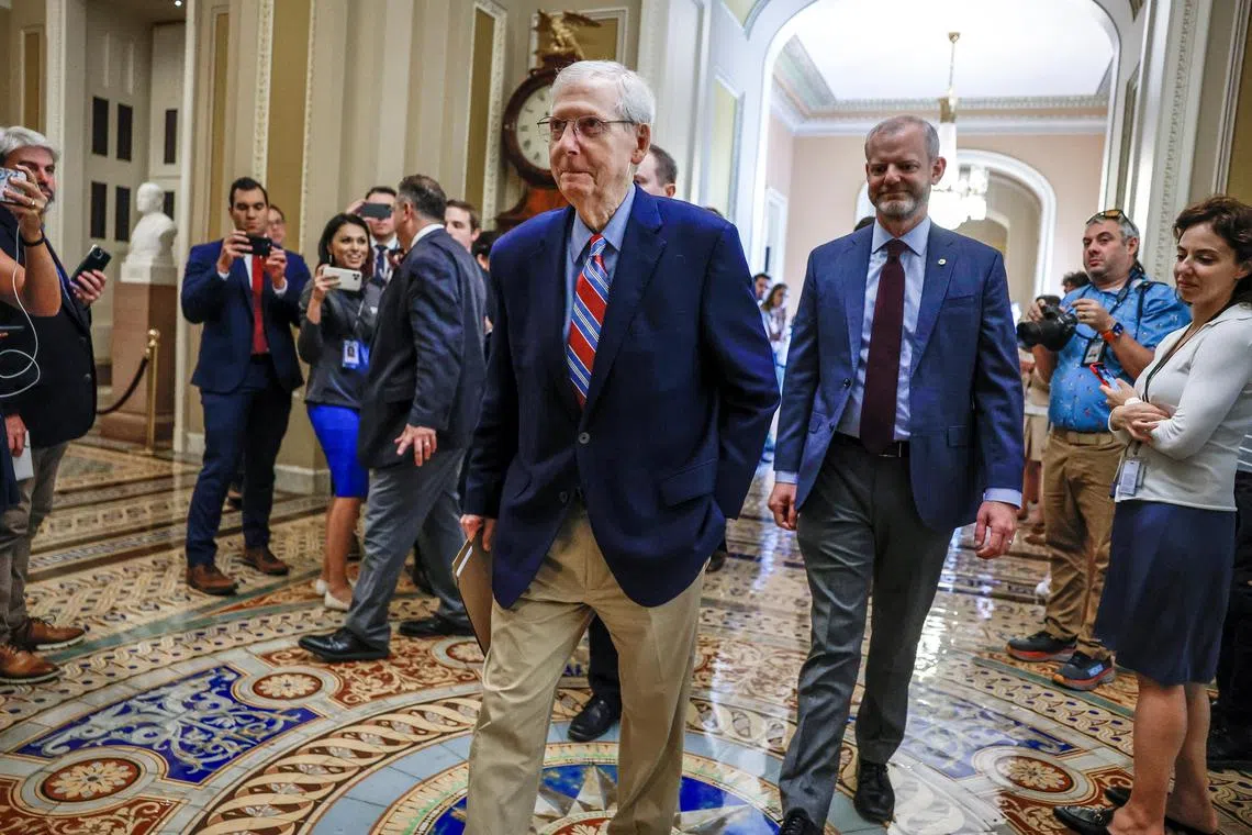 US Senator Mitch McConnell (centre) returns to the Senate floor following the summer recess, amid concerns over two recent "freezing" episodes while speaking in public.