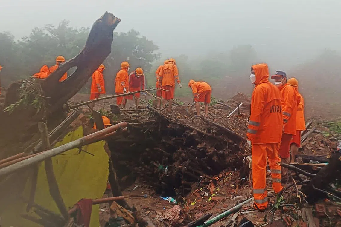 In this handout photograph released by India’s National Disaster Response Force (NDRF) and taken on July 22, 2023, NDRF personnel search for victims at the site of a landslide at Irshalwadi village of Raigad district in Maharashtra state. Hopes faded on July 21 for the survival of dozens missing after a landslide smashed into a village in India, as rescuers battled rains and difficult terrain. So far 22 people have been confirmed dead since the landslide on July 20, India's National Disaster Response Force said. (Photo by India's National Disaster Response Force (NDRF) / AFP) / RESTRICTED TO EDITORIAL USE - MANDATORY CREDIT "AFP PHOTO /  India’s National Disaster Response Force (NDRF) " - NO MARKETING NO ADVERTISING CAMPAIGNS - DISTRIBUTED AS A SERVICE TO CLIENTS