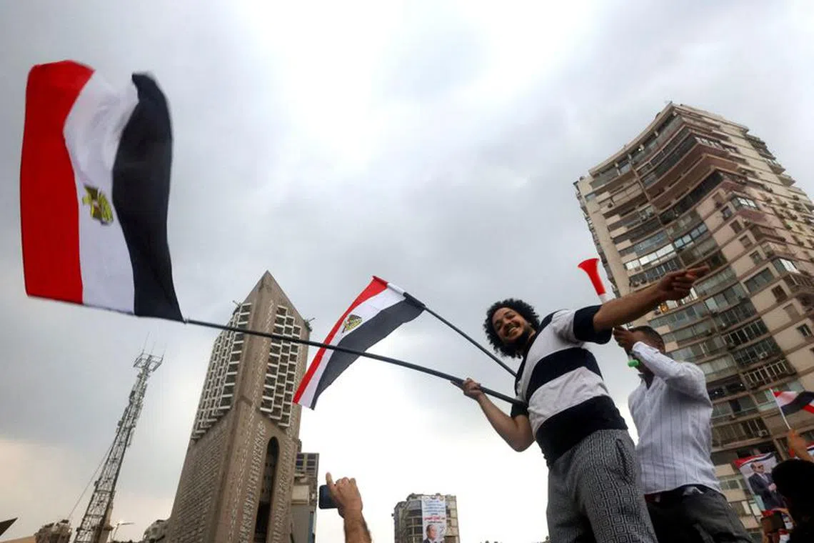 Supporters of Egyptian President Abdel Fattah al-Sisi wave flags during a rally to back his candidacy in the presidential elections in December, at Al Galaa Square in the Dokki district of Giza, Egypt, October 2, 2023. REUTERS/Amr Abdallah Dalsh