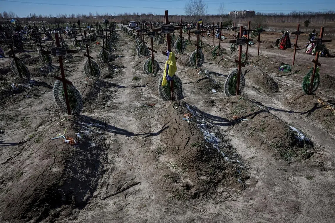 FILE PHOTO: Graves of unidentified people killed by Russian soldiers during occupation of the Bucha town, are seen at the town's cemetery, before the first anniversary of its liberation, amid Russia's attack on Ukraine, in the town of Bucha, outside Kyiv, Ukraine March 30, 2023. REUTERS/Gleb Garanich/File Photo