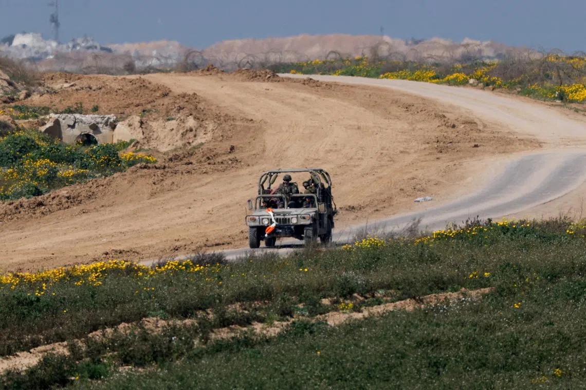 A military vehicle maneuvres near the Israel-Gaza border, amid the ongoing conflict between Israel and the Palestinian Islamist group Hamas, in Israel, February 28, 2024. REUTERS/Amir Cohen/File Photo