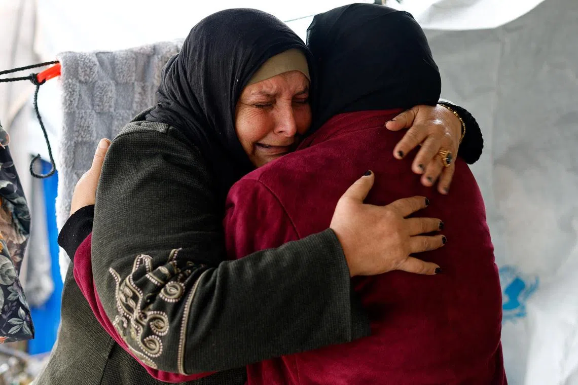 Huda Abu Abed, 56, cries as she is embraced by her sister inside a tent after returning to Gaza through the Rafah crossing, in Khan Younis in the southern Gaza Strip, February 3, 2026. REUTERS/Mahmoud Issa