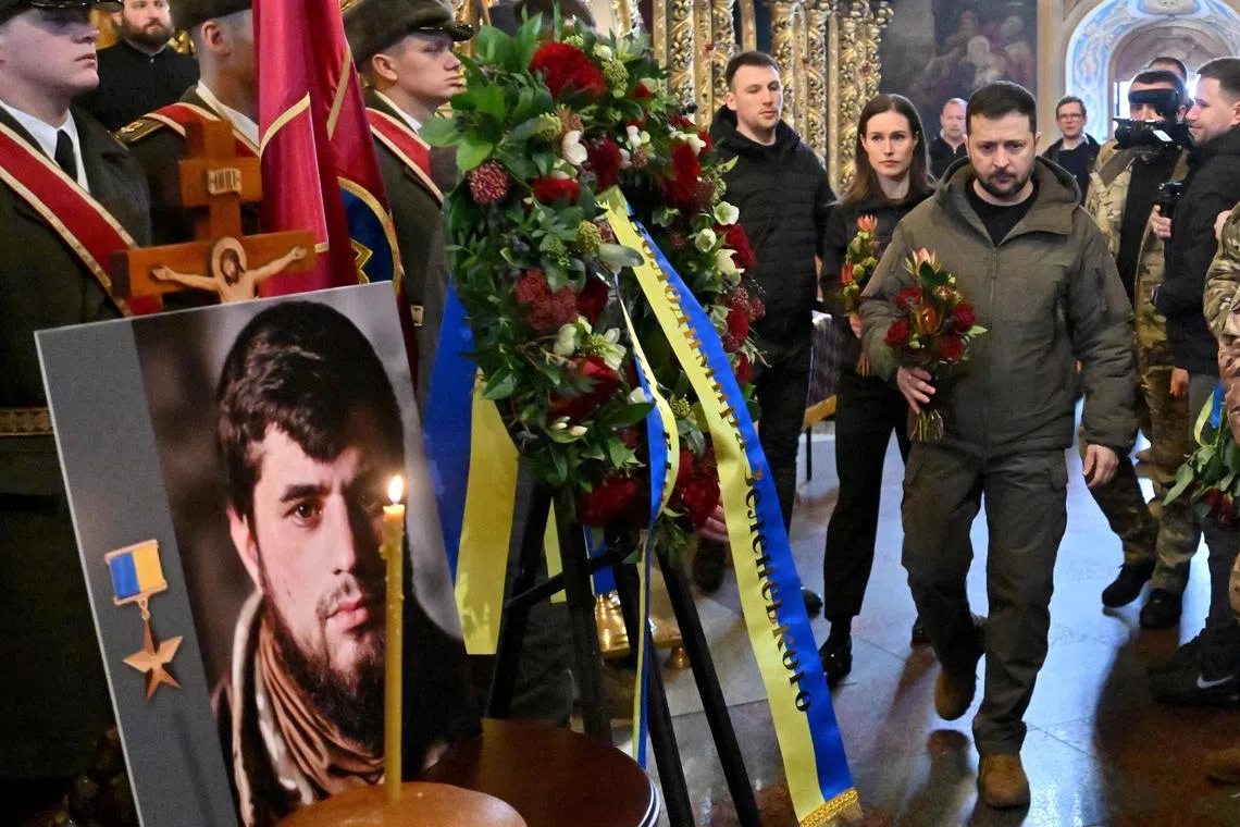 Finnish Prime Minister Sanna Marin (centre) and Ukrainian President Volodymyr Zelensky (centre right) attend the funeral in Kyiv of fallen Ukrainian military commander Dmytro Kotsiubaylo, also known as "Da Vinci".