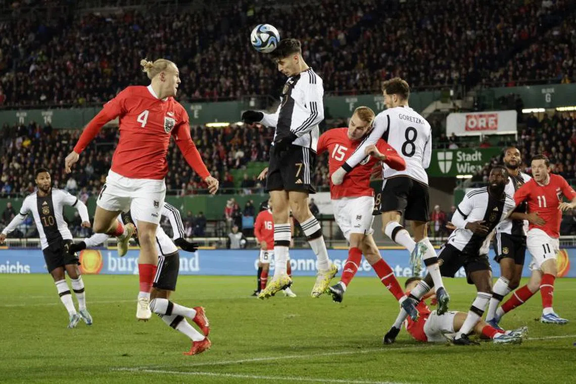 Soccer Football - International Friendly - Austria v Germany - Ernst Happel Stadium, Vienna, Austria - November 21, 2023 Germany's Kai Havertz and Leon Goretzk in action with Austria's Xaver Schlager and Philipp Lienhart REUTERS/Leonhard Foeger