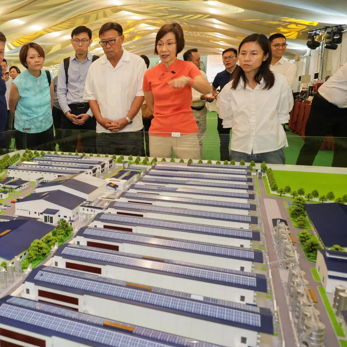 Minister of Sustainability and the Environment Grace Fu (second from right) and Senior Parliamentary Secretary for Sustainability and the Environment Goh Hanyan (right) viewing the scale model of the DoMo farm on Sept 29.