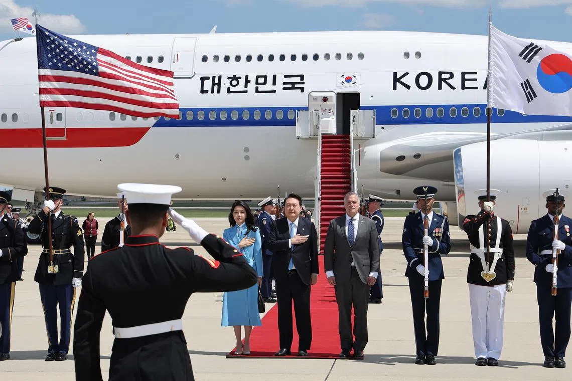 epa10589938 South Korean President Yoon Suk Yeol (5-R) and his wife, Kim Keon Hee (6-R), attend a welcoming ceremony upon arrival at Joint Base Andrews for a six-day state visit, in Prince George's County, Maryland, USA, 24 April 2023.  EPA-EFE/YONHAP SOUTH KOREA OUT