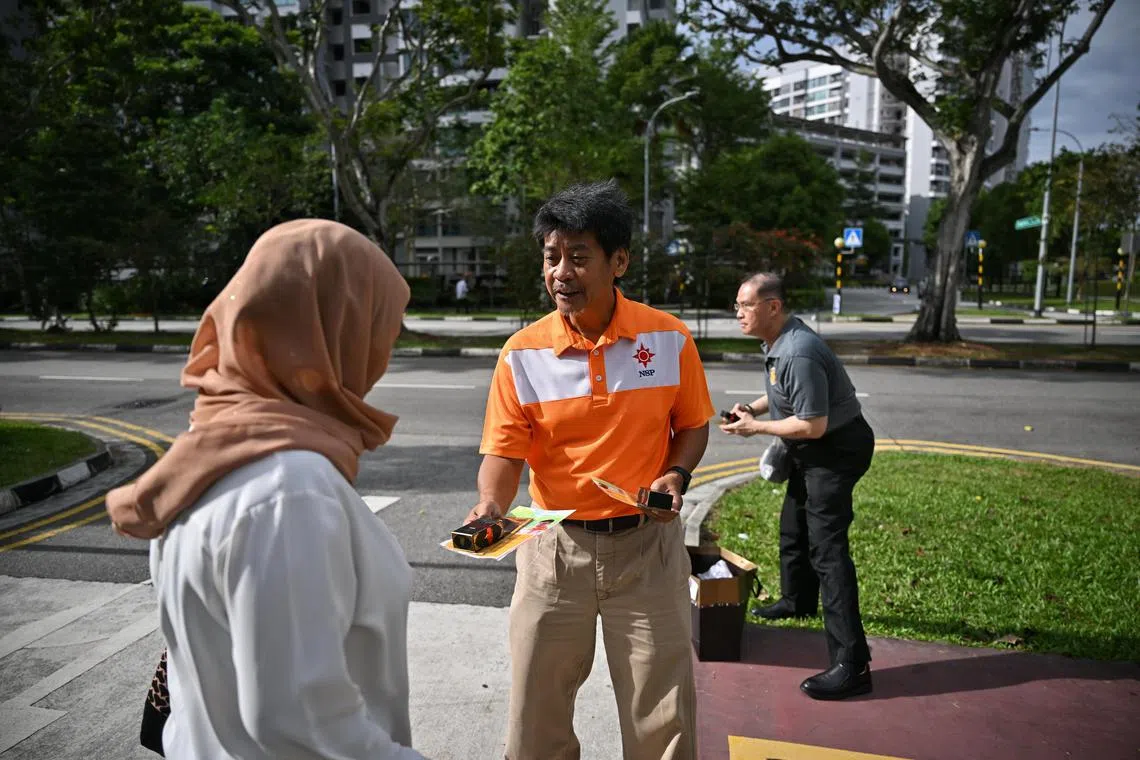 NSP’s vice-president Mohd Ridzwan Mohammad handing out pamphlets and dates outside Masjid Darul Ghufran in Tampines Avenue 5 on March 16.