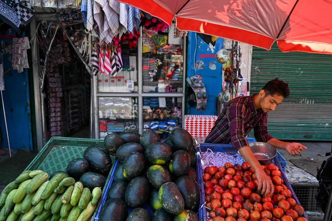 A vendor arranging fruits at a roadside stall in the main town of Poonch district in the Indian-run part of divided Kashmir on May 11.