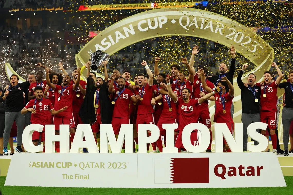 FILE PHOTO: Soccer Football - AFC Asian Cup - Final - Jordan v Qatar - Lusail Stadium, Lusail, Qatar - February 10, 2024 Qatar's Hassan Al-Haydos lifts the trophy with teammates after winning the AFC Asian Cup REUTERS/Molly Darlington/File Photo