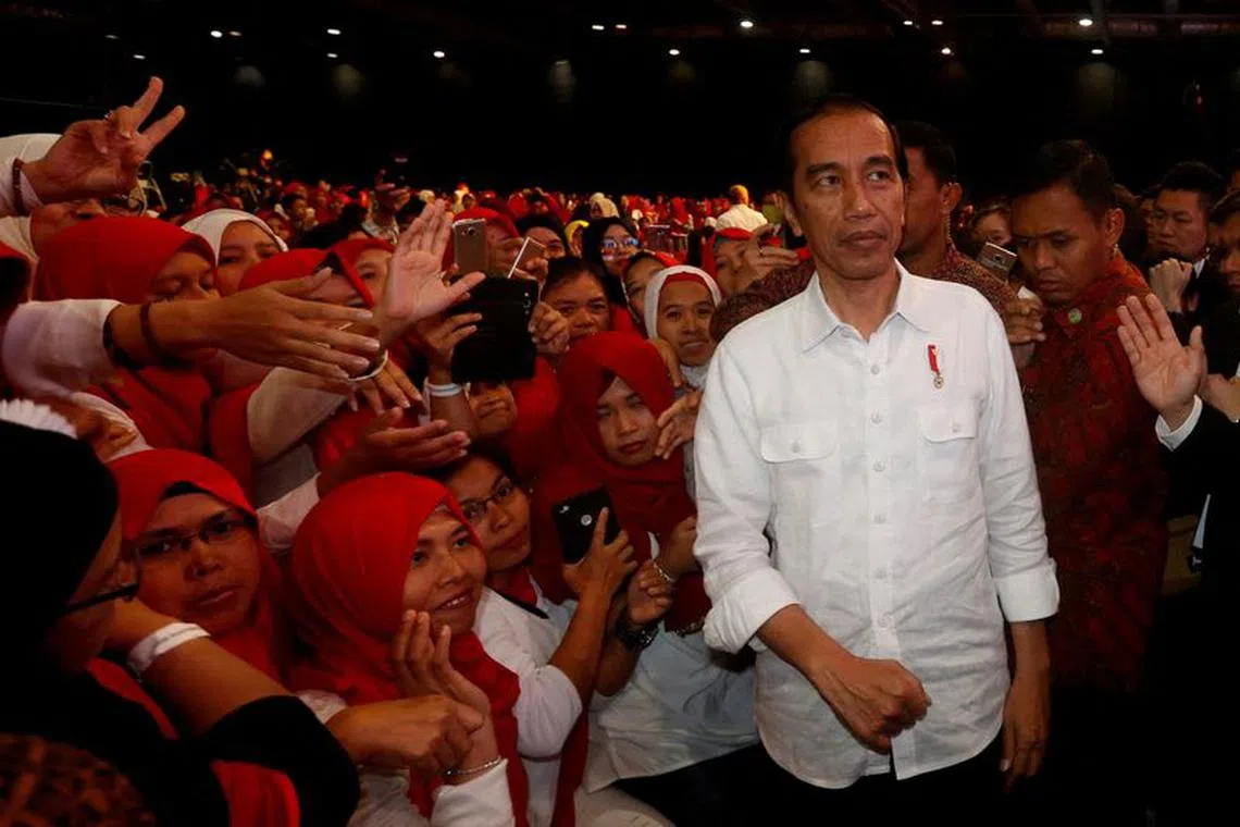 FILE PHOTO: Indonesian President Joko \"Jokowi\" Widodo is greeted by Indonesian migrant workers in  Hong Kong, China, April 30, 2017.      REUTERS/Bobby Yip/File Photo