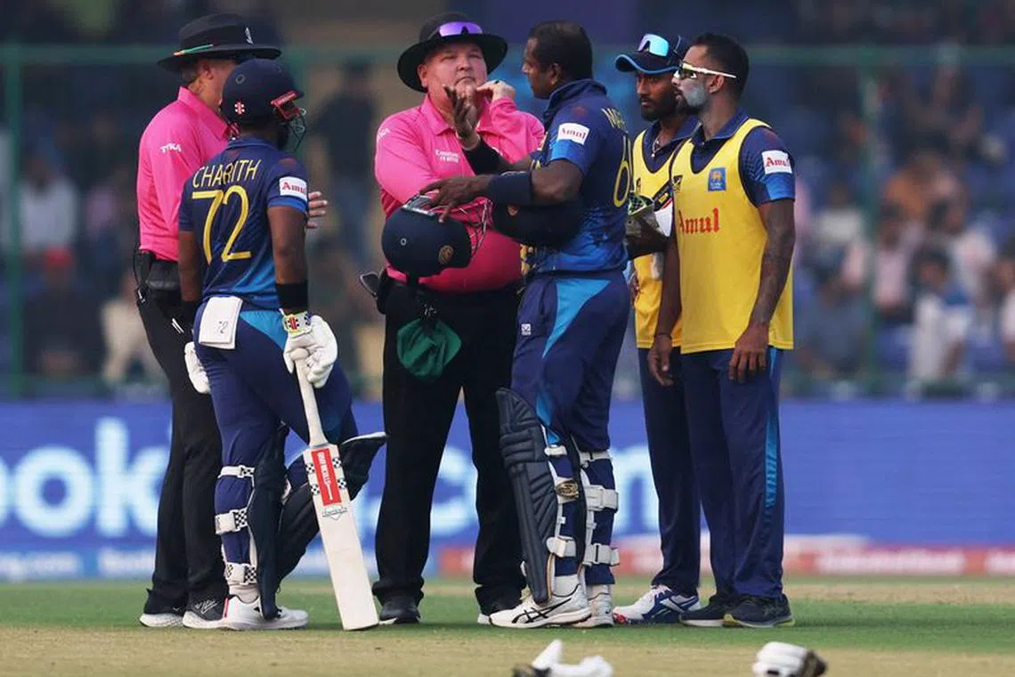 Cricket - ICC Cricket World Cup 2023 - Bangladesh v Sri Lanka - Arun Jaitley Stadium, New Delhi, India - November 6, 2023 Sri Lanka's Angelo Mathews speaks to the umpires after losing his wicket due to time out REUTERS/Anushree Fadnavis
