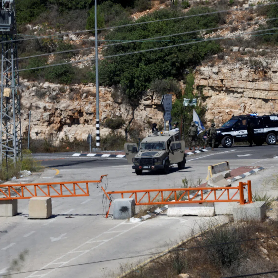 Israeli forces block a checkpoint used by Palestinians after a shooting attack, near Ramallah in the Israeli-occupied West Bank on  Sept 20.